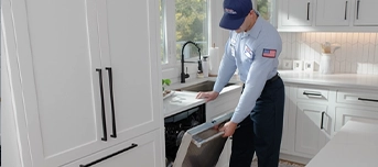 A Roto-Rooter expert service provider conducting a dishwasher installation in Dallas.