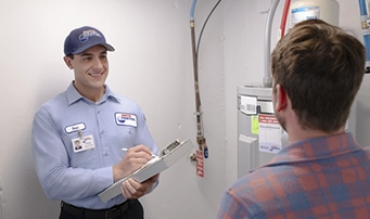 A Roto-Rooter emergency plumber in Dallas reviews pricing and financing options for an urgent water heater repair
