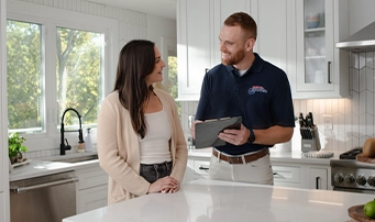 A Roto-Rooter expert talks about financing options with a client