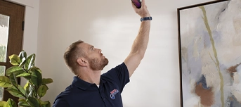 A Roto-Rooter technician using a device to detect leaks for a leak repair in Dallas.