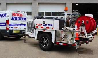 Roto-Rooter jetting equipemnt stored in back of trialer attached to Roto-Rooter van