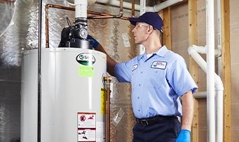 Technician inspecting water heater in preparation for repair
