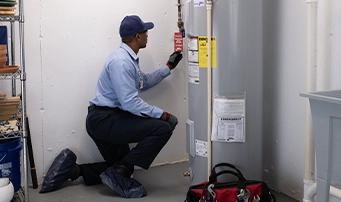 Technician inspecting in preparation for repairing water heater