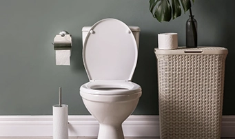 A functioning toilet with an open lid in a bathroom after a toilet repair in Minneapolis.