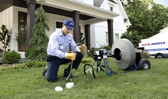 Roto-Rooter technician working on a main sewer line