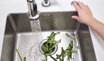 Homeowner experiencing a clog with their garbage disposal in Portland.