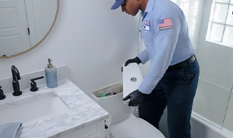 Roto-Rooter technician doing a toilet repair in Portland