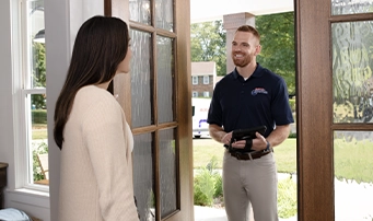 Homeowner with technician before a water heater repair in Portland