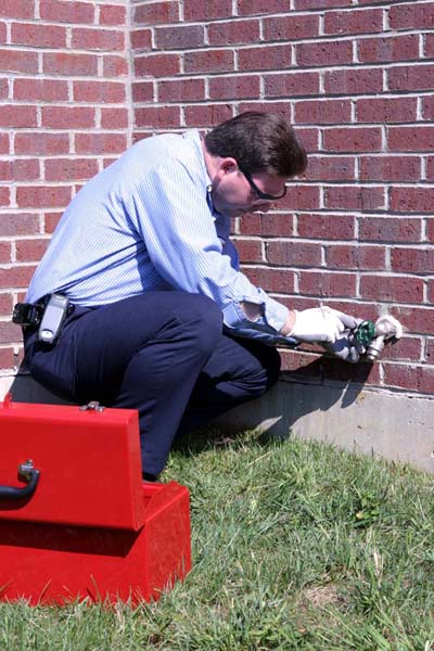 technician fixing an outdoor water line