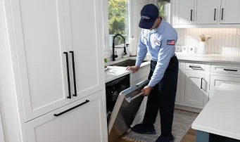 Roto-Rooter Plumber inspecting dishwasher