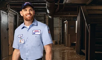 Roto-Rooter technician in flooded basement